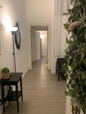 a hallway with a room with a table and a lamp at Mc - Piazza Mancini in Rome