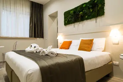 a bedroom with a large bed with two stuffed animals on it at Borghetto Guest House in Rome