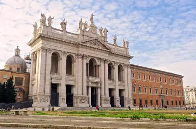 a large building in front of a brick building at Borghetto Guest House in Rome
