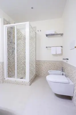 a bathroom with a toilet and a sink and a shower at Lory House in Rome