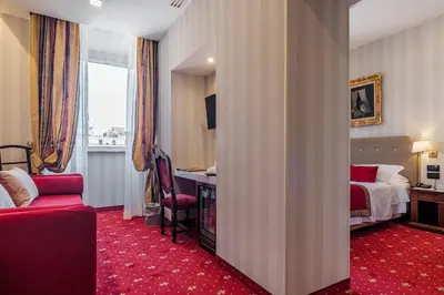 a hotel room with a bedroom with a bed and a desk at Hotel Nazionale in Rome