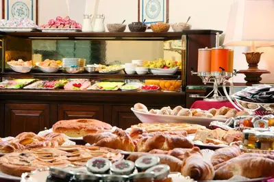 a buffet with many different types of food on a table at Hotel Nazionale in Rome