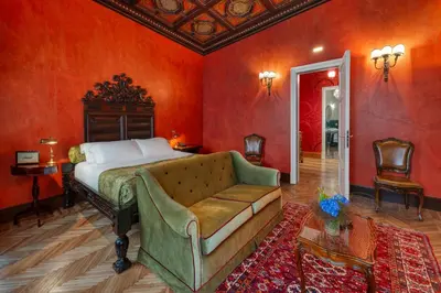 a bedroom with a bed and a couch at Hotel Locarno in Rome