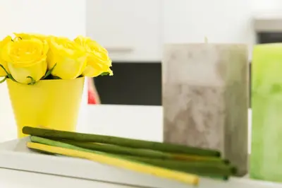 a yellow flower in a yellow container on a table at Casa Brunetti in Rome