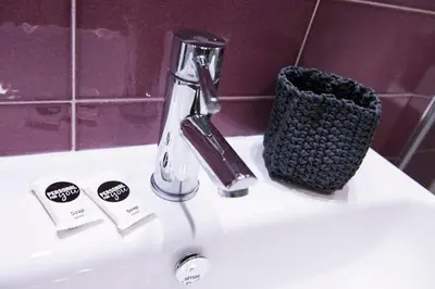 a bathroom sink with a faucet and a toothbrush at Casa Brunetti in Rome