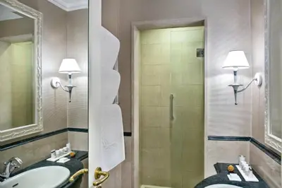 a bathroom with a sink and a shower at Rome Marriott Grand Hotel Flora in Rome