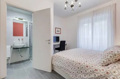 a bedroom with a bed and a sink and a mirror at AV Domus Vatican St.Peter B&B in Rome