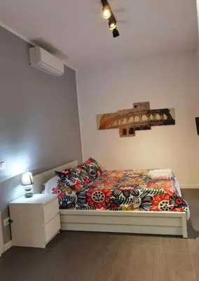 a bedroom with a bed with a colorful blanket at AV Domus Vatican St.Peter B&B in Rome