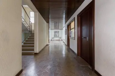a hallway of a building with stairs and a door at AV Domus Vatican St.Peter B&B in Rome