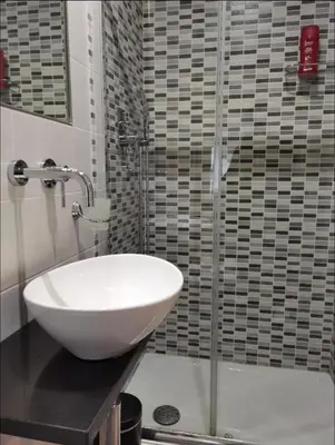 a bathroom with a white sink and a shower at AV Domus Vatican St.Peter B&B in Rome