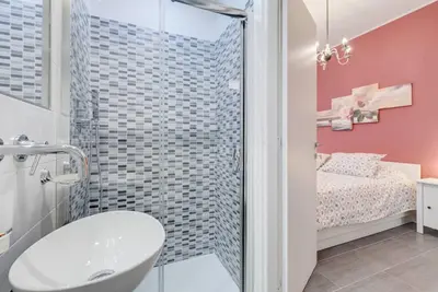 a bathroom with a shower and a sink and a bed at AV Domus Vatican St.Peter B&B in Rome