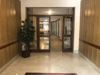 an office hallway with doors and a potted plant at Dormi a Roma in Rome