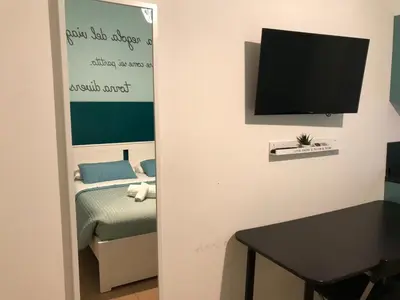 a room with a bed and a television on a wall at Dormi a Roma in Rome