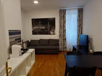 a living room with a couch and a table at Apollo Apartments Colosseo in Rome