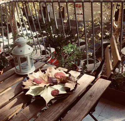a wooden bench with a bouquet of flowers on it at B&B Stelle Di Roma in Rome