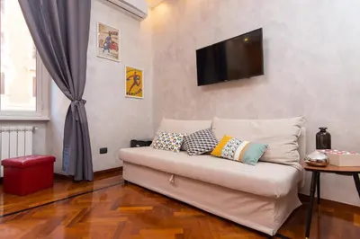 a living room with a couch with pillows on it at B&B Arco Di Gallieno in Rome