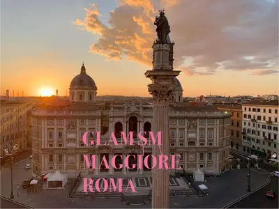 a large building with a statue in front of it at Glam Sm Maggiore Guest House in Rome