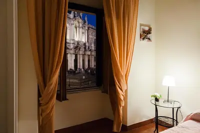 a bedroom with a picture of the palace ofminster at Glam Sm Maggiore Guest House in Rome