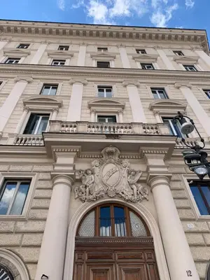 a building with a clock on the front of it at Glam Sm Maggiore Guest House in Rome