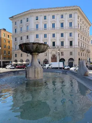 a fountain in front of a large building at Glam Sm Maggiore Guest House in Rome