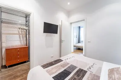 a bedroom with a bed and a tv on a wall at About Colosseo - Appartamento al Colosseo nel cuore di Roma - Free WiFi in Rome