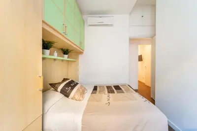 a small bedroom with a bed in a room at About Colosseo - Appartamento al Colosseo nel cuore di Roma - Free WiFi in Rome