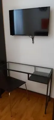 a flat screen tv hanging on a wall at Retro Rooms Termini in Rome