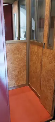 a room with two glass doors and a red floor at Retro Rooms Termini in Rome