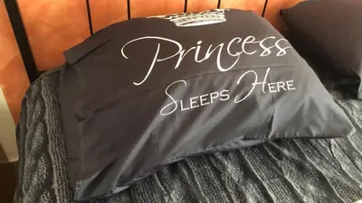 a shirt that says princess sleeps here on a bed at L'Angolo Di San Pietro in Rome