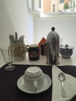 a kitchen counter with a tea kettle and a plate and spoon at L'Angolo Di San Pietro in Rome