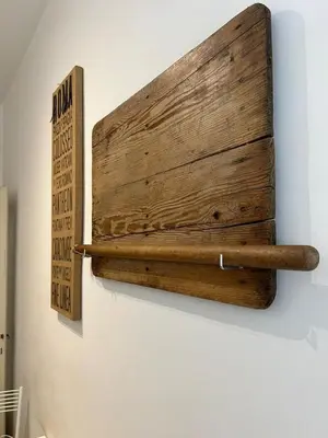 a wooden sign on a wall with two baseball bats at L'Angolo Di San Pietro in Rome