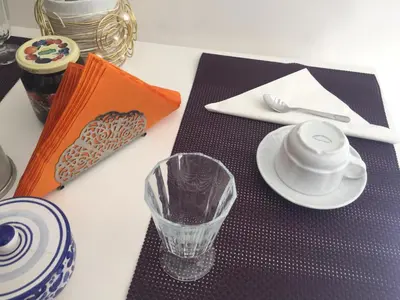 a table topped with purple place settings with a cup and a plate at L'Angolo Di San Pietro in Rome