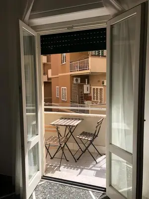 a glass door leading to a patio with a table at L'Angolo Di San Pietro in Rome