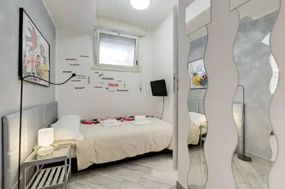 a small room with a bed and a window at Rome Apartment with terrace Autonomous in Rome