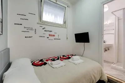 a bedroom with a bed with words on the wall at Rome Apartment with terrace Autonomous in Rome