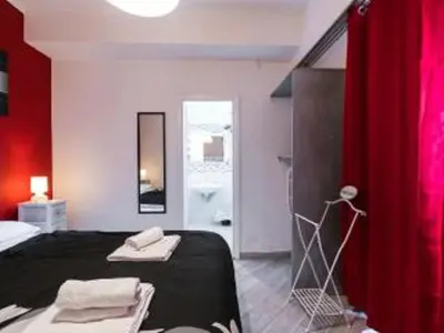 a bedroom with a bed and a red curtain at Rome Apartment with terrace Autonomous in Rome