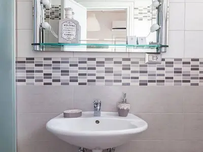a bathroom with a sink and a mirror at Rome Apartment with terrace Autonomous in Rome