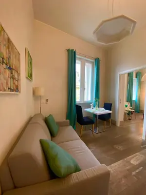 a living room with a couch and a table at Spain Apartments in Rome
