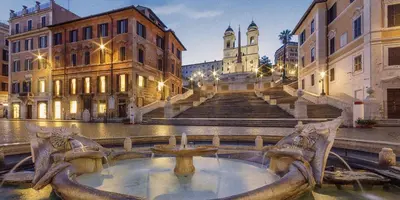 a building with a fountain in the middle of a street at Spain Apartments in Rome