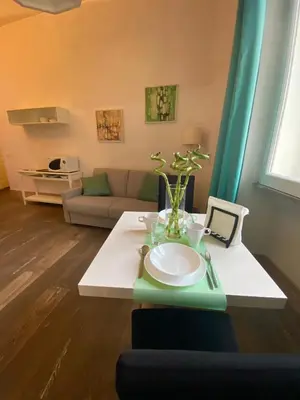 a living room with a table and a couch at Spain Apartments in Rome