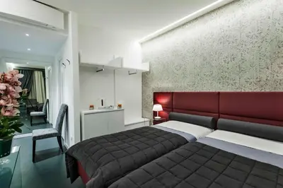a bedroom with a bed and a red headboard at Residenza Monfy in Rome