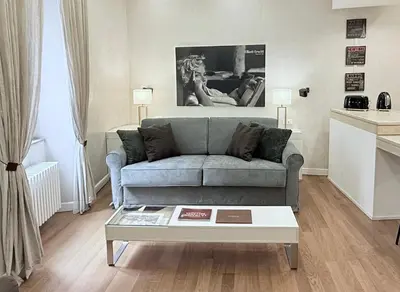 a living room with a couch and a coffee table at Campo dei Fiori modern apartment with terrace in Rome