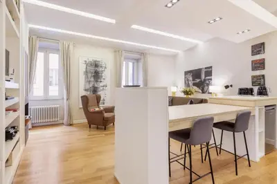 a kitchen and living room with a table and chairs at Campo dei Fiori modern apartment with terrace in Rome