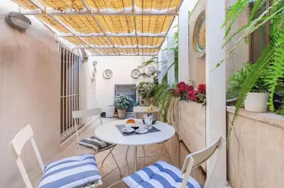 a small balcony with a table and chairs at Campo dei Fiori modern apartment with terrace in Rome