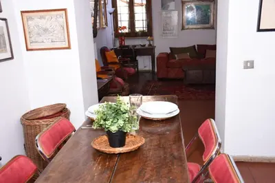 a wooden table with plates and a plant on it at Agrippa's Terrace in Rome