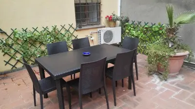 a black table and chairs on a patio at Agrippa's Terrace in Rome