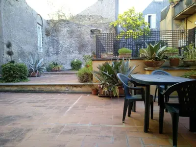 a patio with a table and chairs and a wall at Agrippa's Terrace in Rome