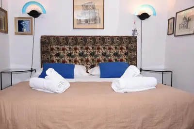 a bedroom with a large bed with white pillows at Agrippa's Terrace in Rome
