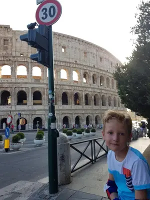 a bus is parked in front of the coliseum at Guest House Hello Roma in Rome