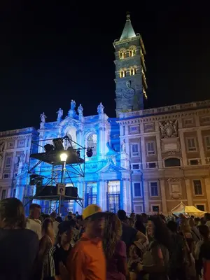 a crowd of people standing in front of a building with a clock tower at Guest House Hello Roma in Rome